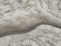 a close up of a sand sculpture on the beach